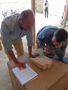 Daniel and Huw deciphering the inscription on an offering table. Photo: Lara Weiss.