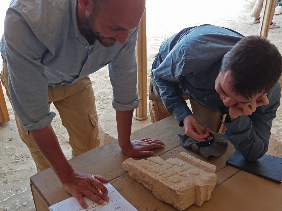 Daniel and Huw deciphering the inscription on an offering table. Photo: Lara Weiss.